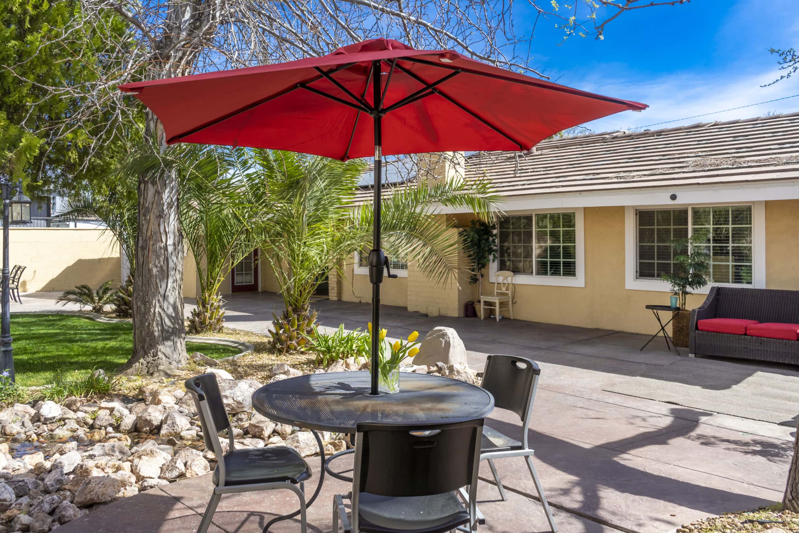 Outdoor tables and chairs with red umbrella